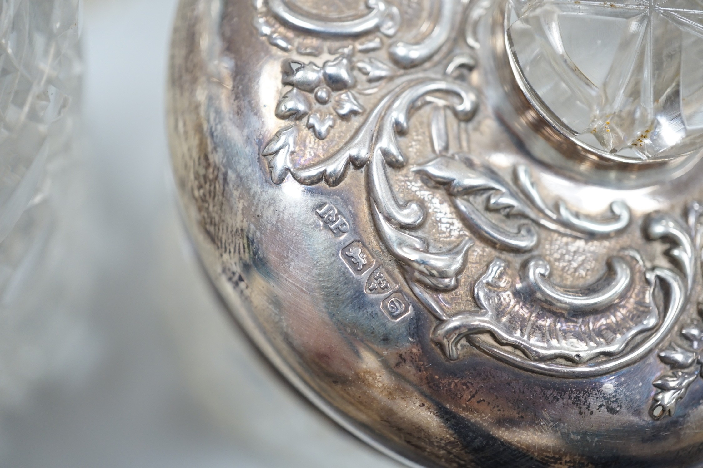 A collection of fourteen assorted late 19th/early 20th century silver mounted cut glass toilet jars or scent bottles, largest 15.5cm, some a.f.